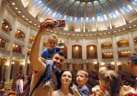 (240602) -- BUCHAREST, June 2, 2024 (Xinhua) -- A family take selfies inside the main hall of the Deputy Chamber during an open-door event marking the International Children\'s Day at Romania\'s Parliament Palace in Bucharest, Romania, June 1, 2024. (Photo by Cristian Cristel\/Xinhua