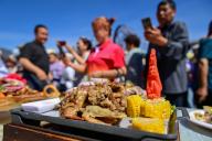 (240602) -- YUMIN, June 2, 2024 (Xinhua) -- People take photos of lamb dishes during a lamb cooking contest in Yumin County of Tacheng Prefecture, northwest China