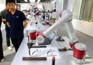 (240603) -- SHANGHAI, June 3, 2024 (Xinhua) -- A robot demonstrates Chinese calligraphy writing at an exhibition hall of JAKA Robotics in east China
