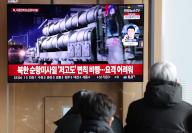 N. Korean missile launch People watch a TV news report on North Korea