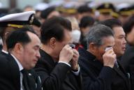Commemoration of soldiers lost in inter-Korean naval clashes President Yoon Suk Yeol (2nd from L) sheds tears while listening to a letter read by Kim Hae-bom, sent to her late father, Master Sergeant Kim Tae-seok, one of 55 troops who perished in three major western naval skirmishes with North Korea, during their annual memorial ceremony at the Navy
